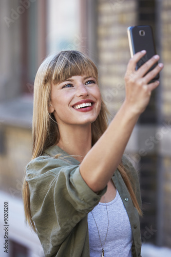 Beautiful woman posing for selfie on smart phone