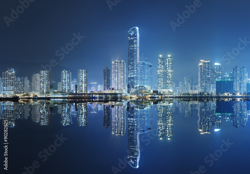 Modern buildings and harbor in Hong Kong at night