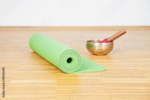 Germany, Cologne, Yoga mat, Klangschale, wooden floor, oak wood, photo