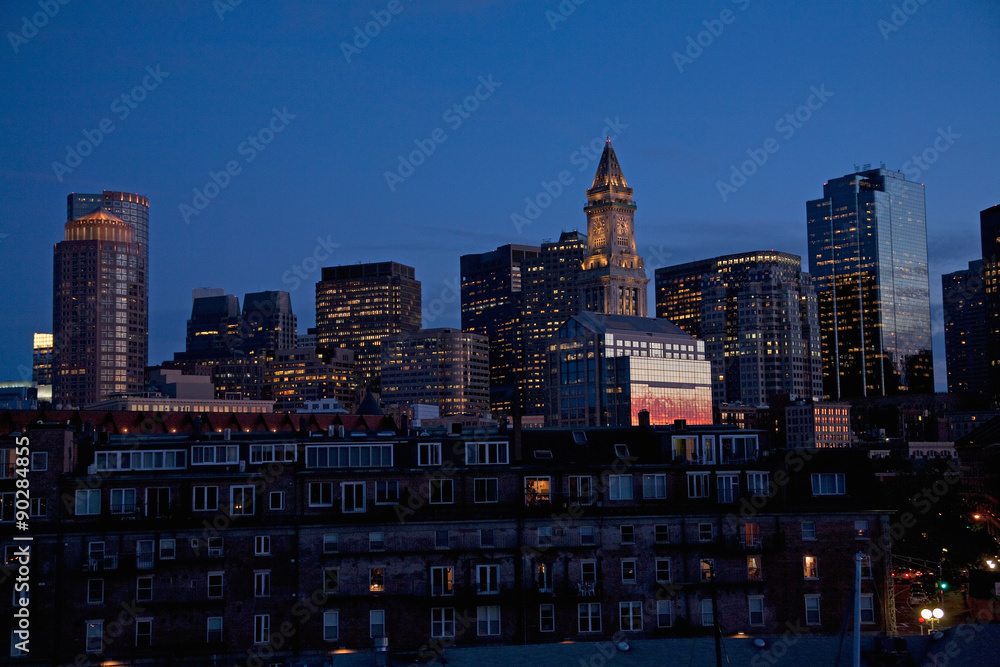 Fototapeta premium Sunset reflects in windows of Boston skyline Commerce House Tower shot at dusk, Boston, MA.