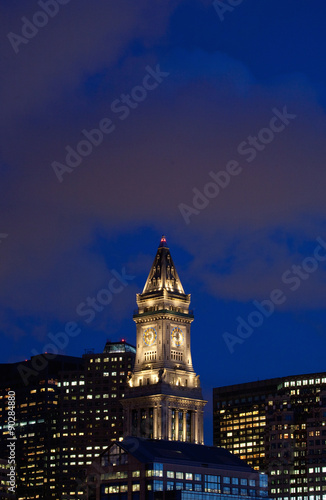 Sunset reflects in windows of Boston skyline and Commerce House Tower shot at dusk, Boston, MA.