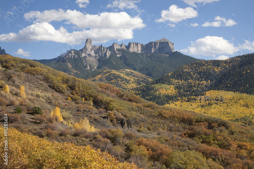 Chimney Peak with white puffy clouds showing Courthouse Mountain in the Uncompahgre National Forest, Colorado.