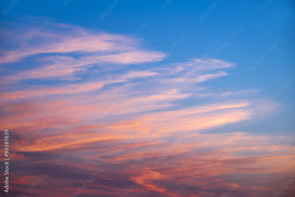 Pink and orange clouds in a blue sky at sunset