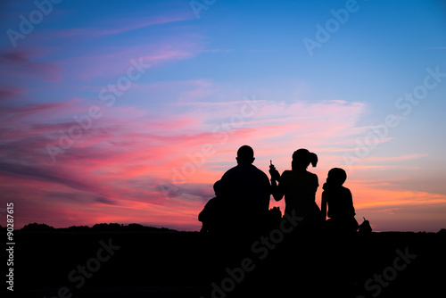 Silhouette of a family enjoying a beautiful sunset