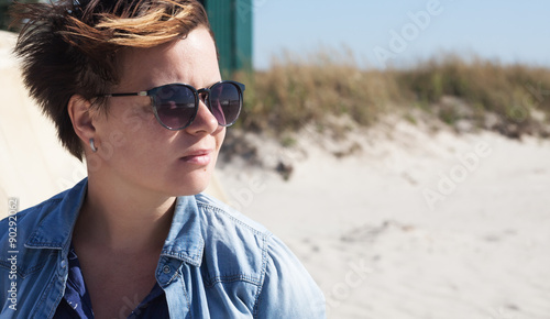 Portrait of young woman with sunglasses on the beach