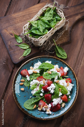 Salad with fresh spinach, strawberries and cheese, above view