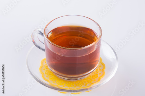 Tea in glass cup or glass cup of black tea on a background.