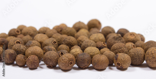 Grains of allspice isolated on white
