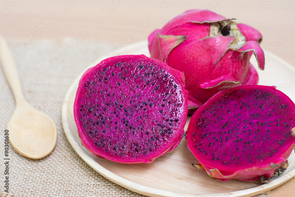 Fresh dragon fruit on wooden bowl Fresh dragon fruit on wooden bowl
