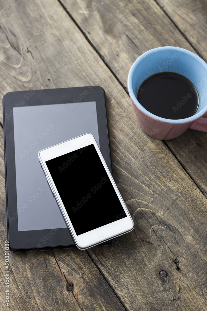 phone and tablet pc on wooden desk phone and tablet pc on wooden desk