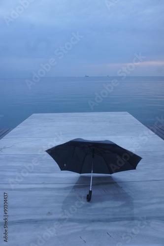 blue umrella Blie umbrella in a port in a greek town