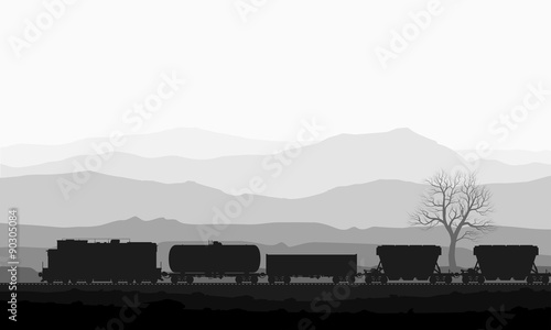 Train with freight wagons over huge mountains.