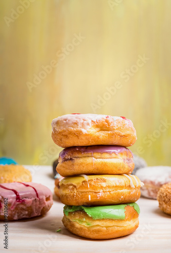 fresh baked homemade colorful donuts on light background