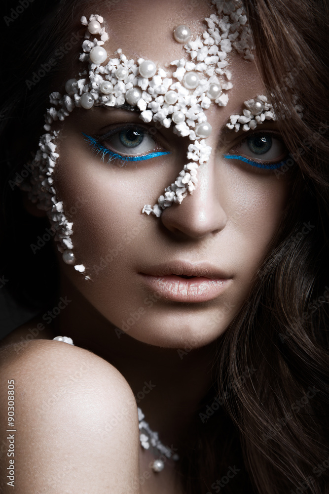 Beautiful dark-haired girl with a fashionable creative makeup