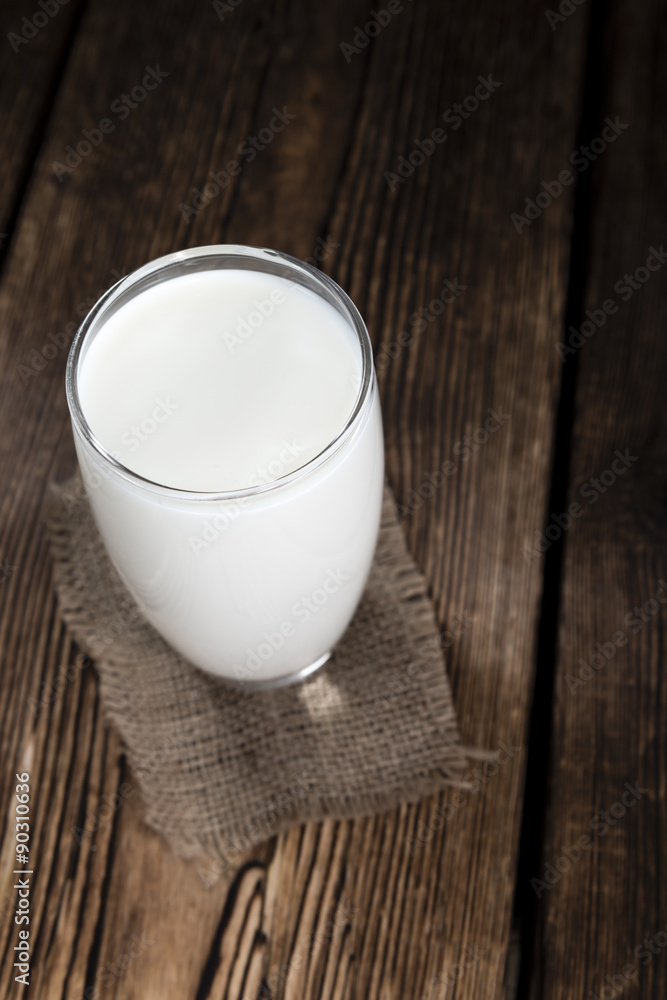 Milk on a dark wooden background Milk on a dark wooden background