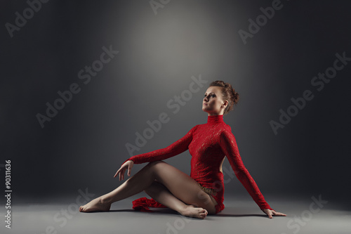 Graceful red-haired dancer froze in pose