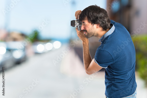 Man photographing over white background