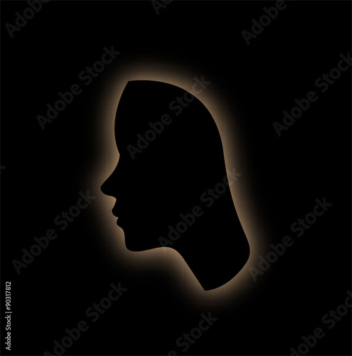 Outline of the form of a womans face in the dark