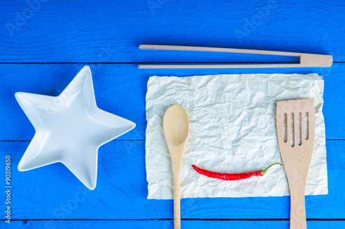 Kitchenware and chili pepper on a sheet of paper