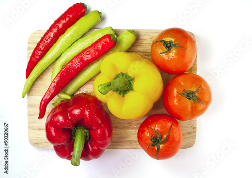 Mixed collection of fresh organic vegetables isolated on a white background. Healthy vegetarian food with wooden bowl of salad.