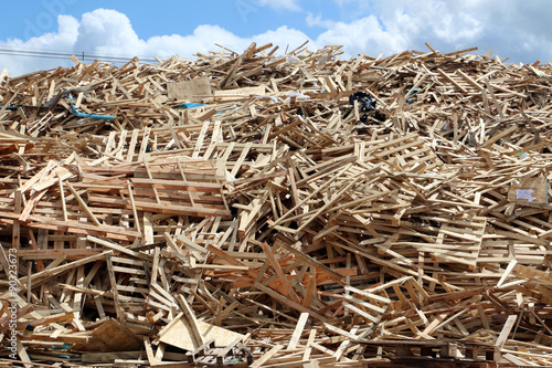 Huge pile of used broken pallets on factory field