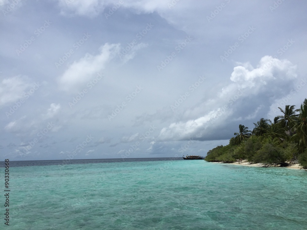 Tropical island and ocean in cloudy weather
