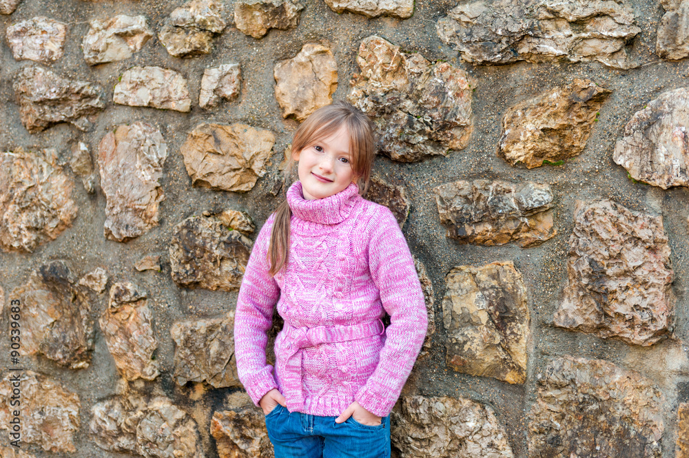 Outdoor portrait of adorable little girl wearing pink pullover Outdoor portrait of adorable little girl wearing pink pullover