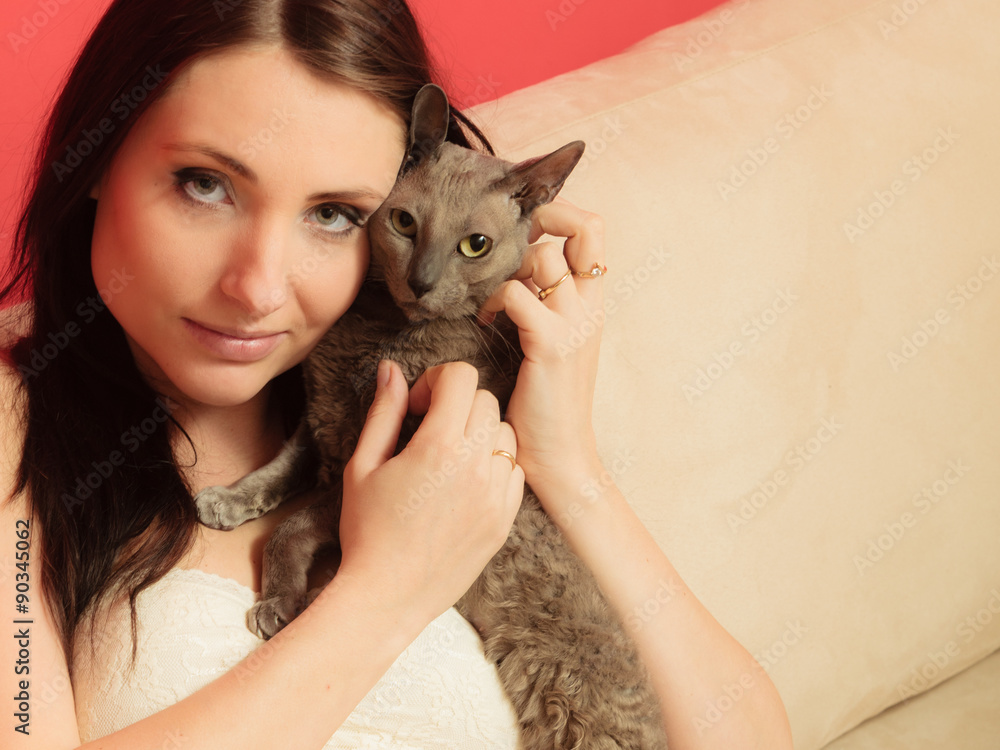 Obraz premium woman on sofa playing with cat