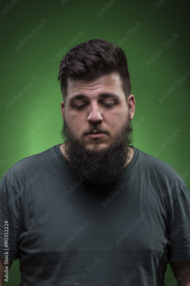 men portrait looking down. Green screen background.