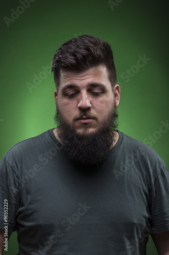 men portrait looking down. Green screen background.