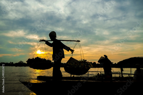 Vietnam woman florist vendor on a boat in early moring © cristaltran