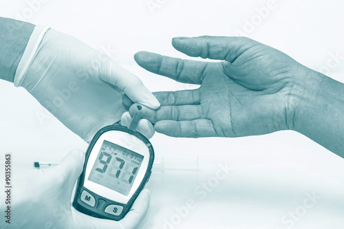 blood glucose meter, the blood sugar value is measured on a finger in blue tone
