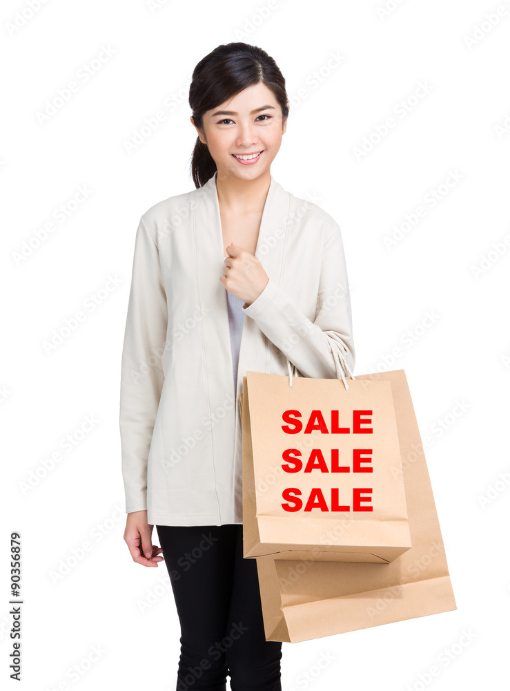 Young woman holding shopping bag and showing three sale word Young woman holding shopping bag and showing three sale word