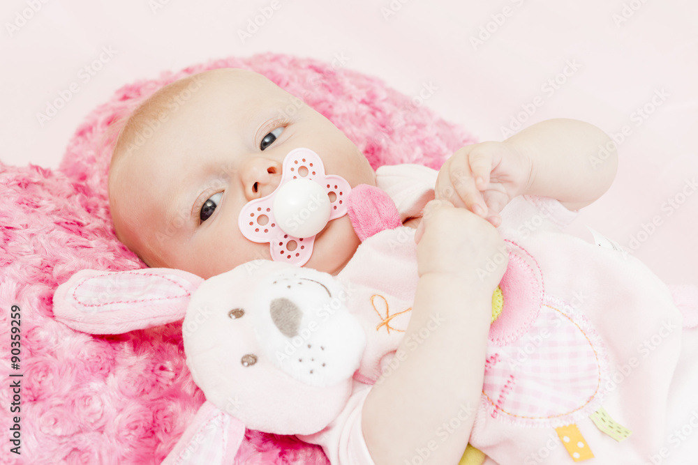 portrait of three months old baby girl with a toy portrait of three months old baby girl with a toy