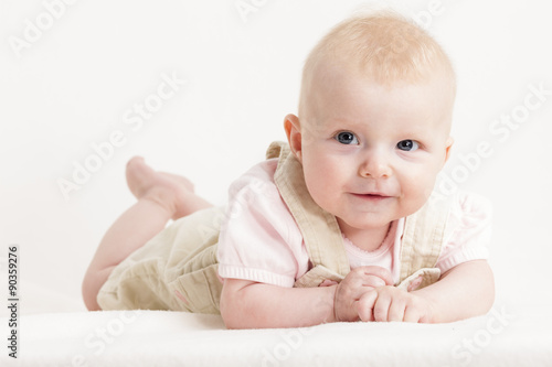 portrait of lying four months old baby girl