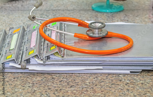 medical history folder  with stethoscope  on marble stone desk