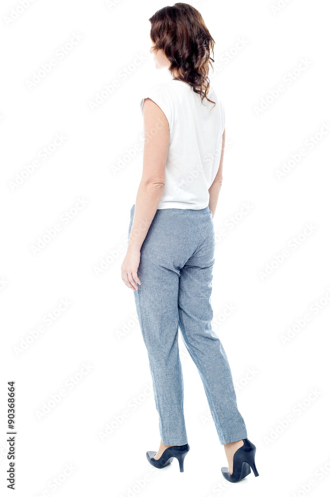Walking stylish woman from back Walking stylish woman from back