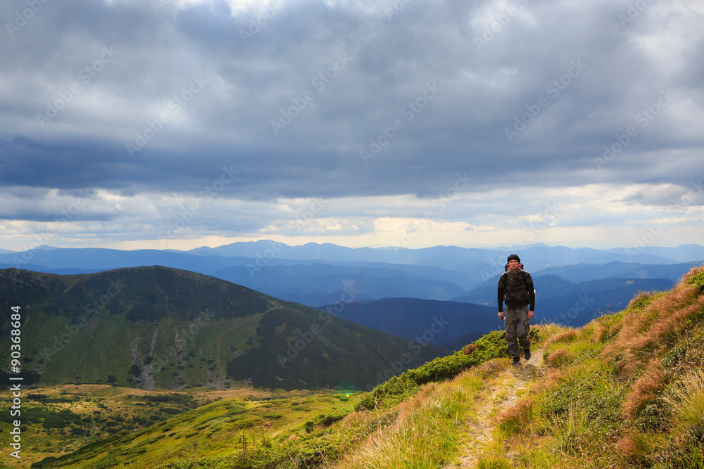 Man traveler hiking in the mountains