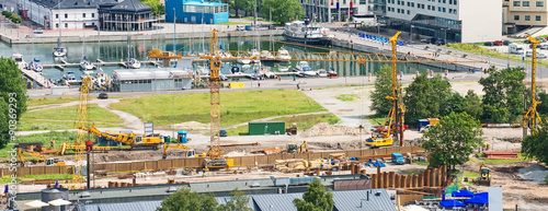Construction site with cranes near city harbour.