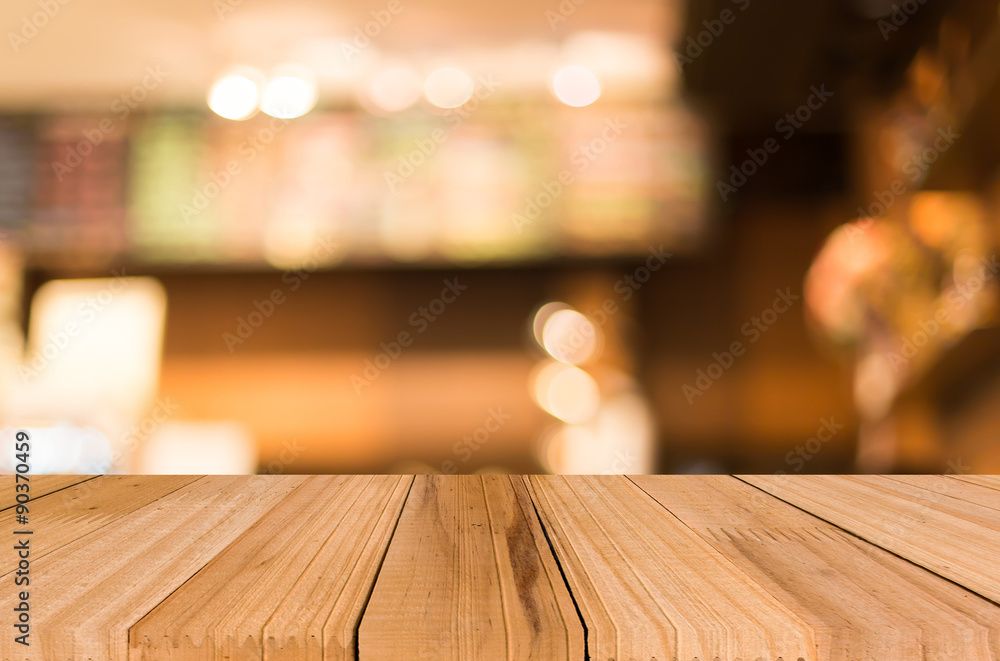 Selected focus empty brown wooden table and Coffee shop blur bac