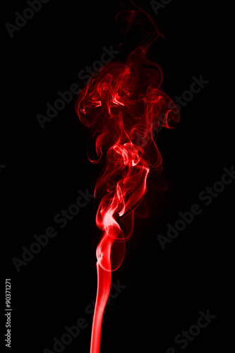 Red smoke on a black background.