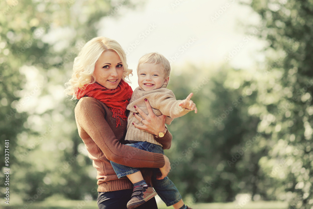 Fototapeta premium Portrait of happy mother and child playing and having fun togeth