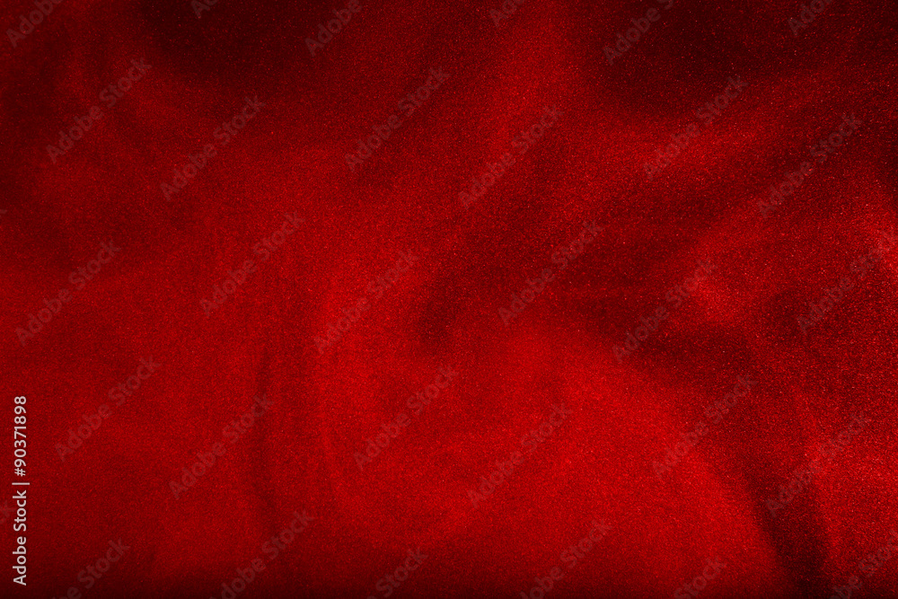 Red powder cloud against dark background Red powder cloud against dark background