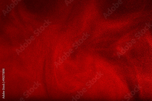 Red powder cloud against dark background