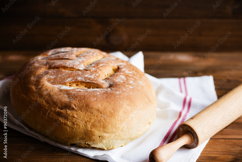 Freshly baked homemade bread on wooden background