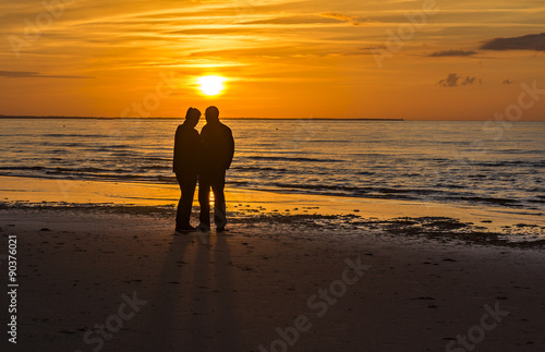 Couple of happy seniors at sandy beach of the Baltic Sea