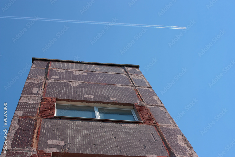 the building and trace of  airplane in  sky