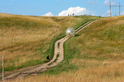 attraction zorbing ball rolling downhill inside an orb photo