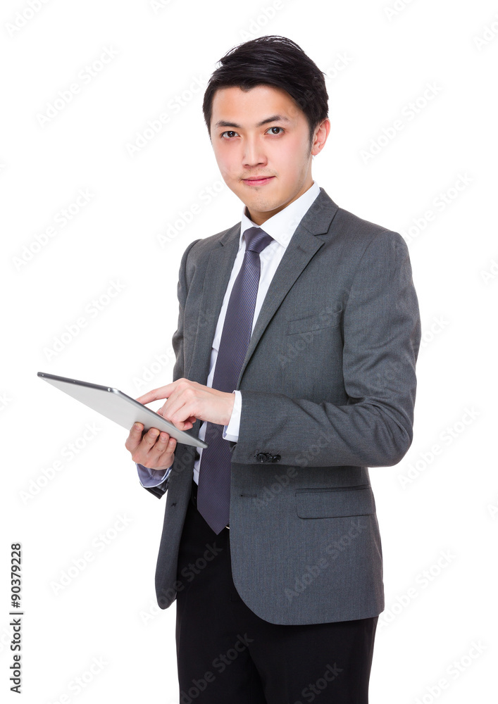 Asian young businessman use of the digital tablet pc Asian young businessman use of the digital tablet pc