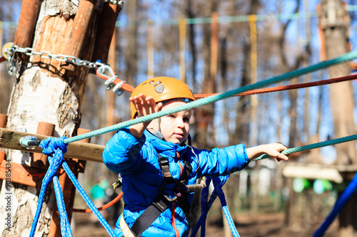 little boy climbing in adventure activity park